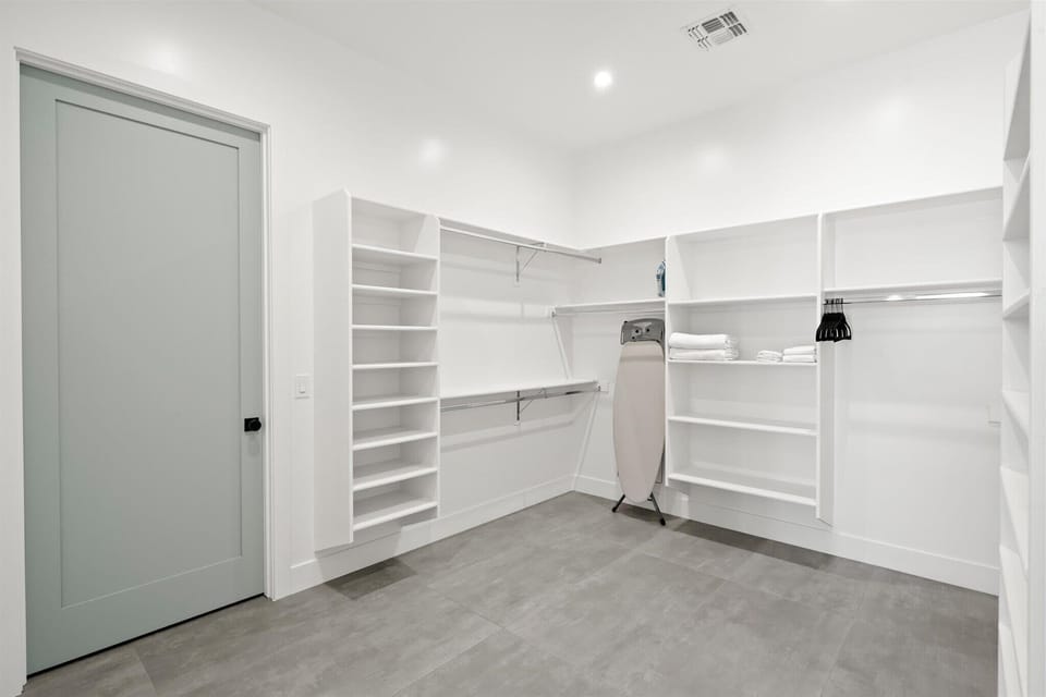  Walk-in closet with ample storage and shelving.
