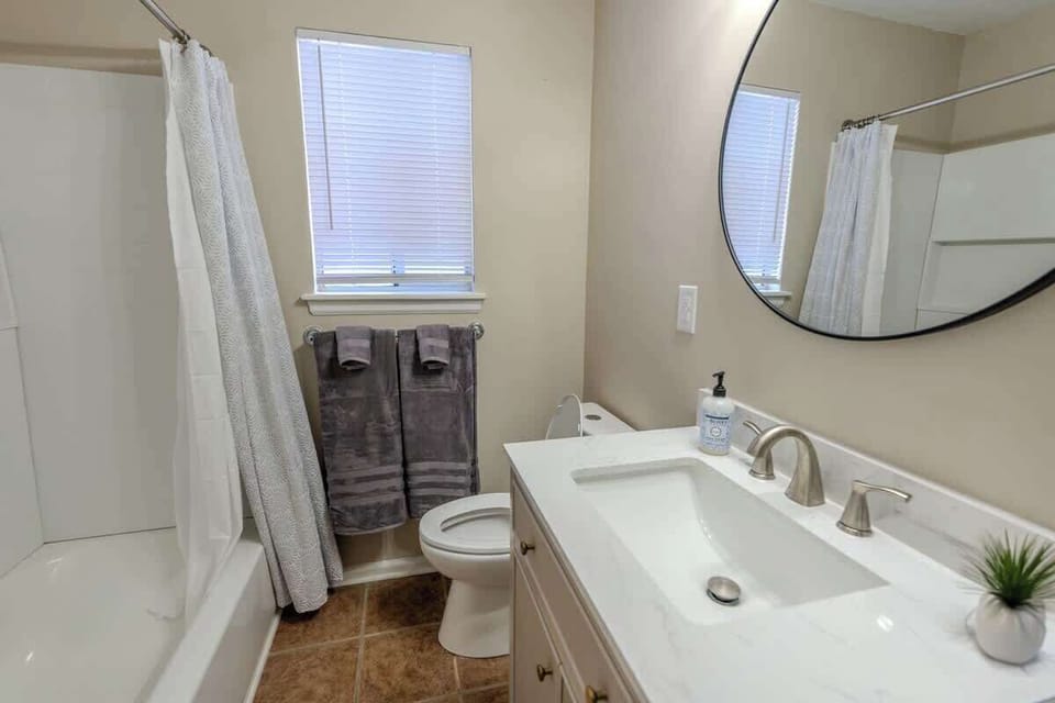 Bathroom with sink, mirror, and shower