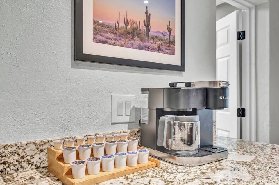 The coffee maker is a high-quality, modern machine with a sleek design, often featuring a stainless steel or black finish. It has a user-friendly interface .