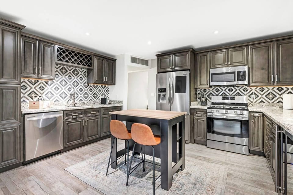 A wide, spacious kitchen designed for both functionality and style, offering ample room for cooking, dining, and socializing.