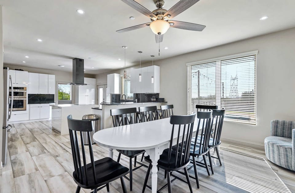 "Our spacious long dining table provides ample room for everyone to enjoy a delicious meal together, making it the heart of your stay."