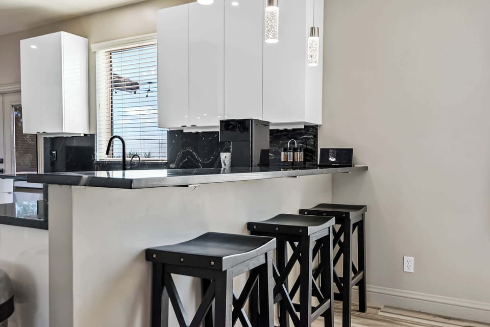 “Step into this sleek, modern kitchen where elegance meets functionality. The perfect spot to whip up culinary masterpieces or enjoy a casual breakfast. 🍳✨”