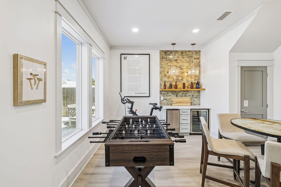 Challenge friends to foosball while you sip drinks from your elegant wet bar in this bright entertainment space.