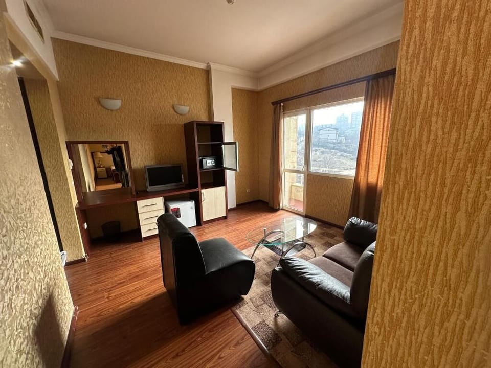 Family Quadruple Room | Living area | TV