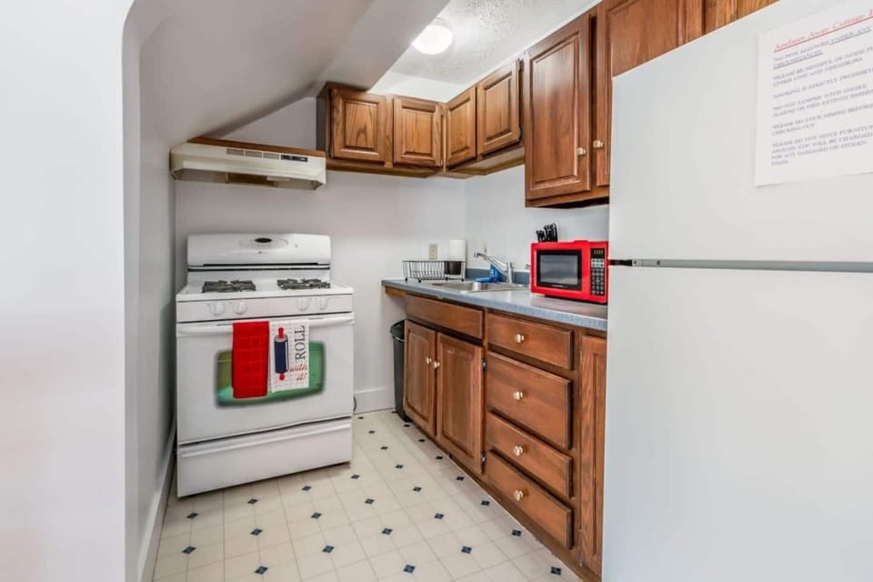 Fully equipped kitchen with warm wood cabinetry, a gas range, and ample counter space. Stocked with all the essentials to easily prepare home-cooked meals during your stay
