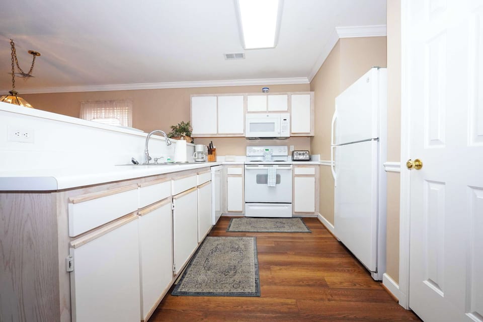 Fully equipped kitchen with dishwasher, essential appliances, and plenty of storage—easy meals made easy.