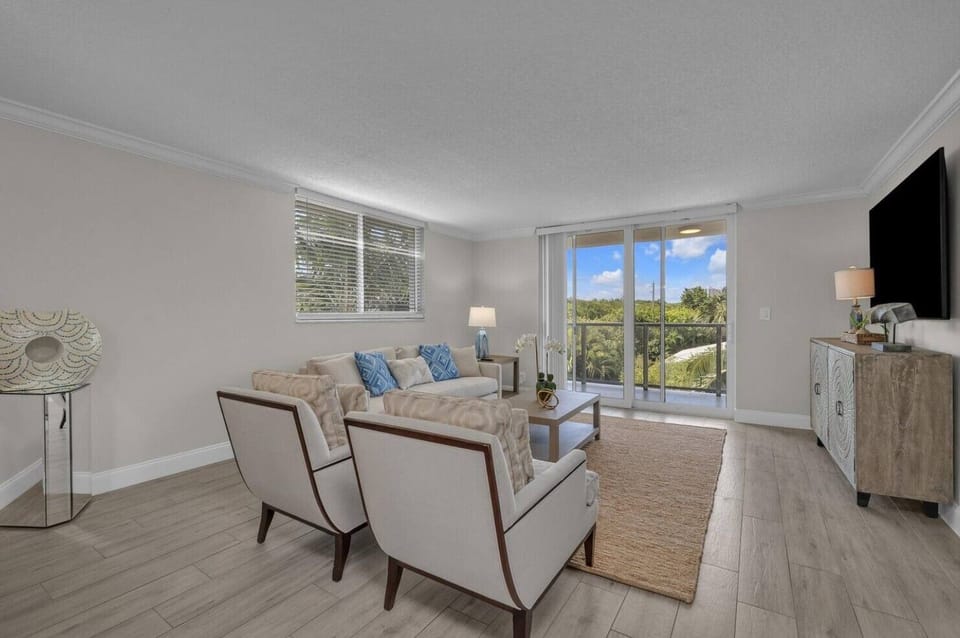 Cozy living room with balcony views and a TV for entertainment.