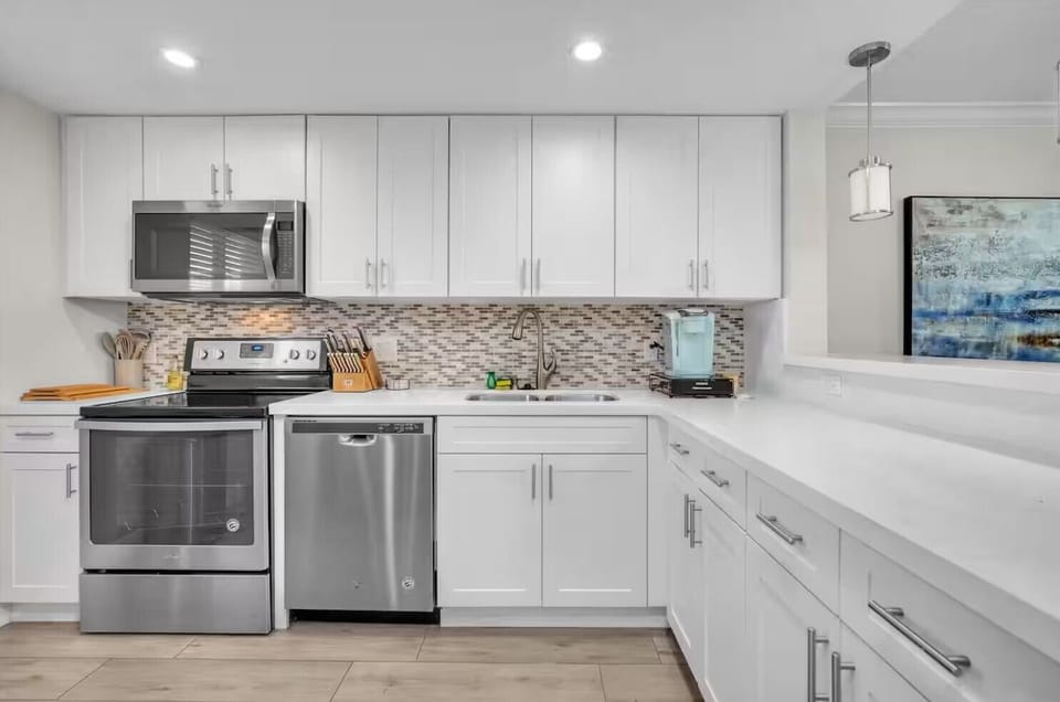 Fully stocked kitchen with essentials, coffee, tea, and cooking tools.