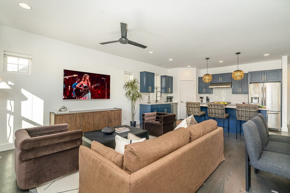 Relax in the cozy and stylish living room, complete with comfortable seating, a flat-screen TV, and large windows that bring in plenty of natural light.