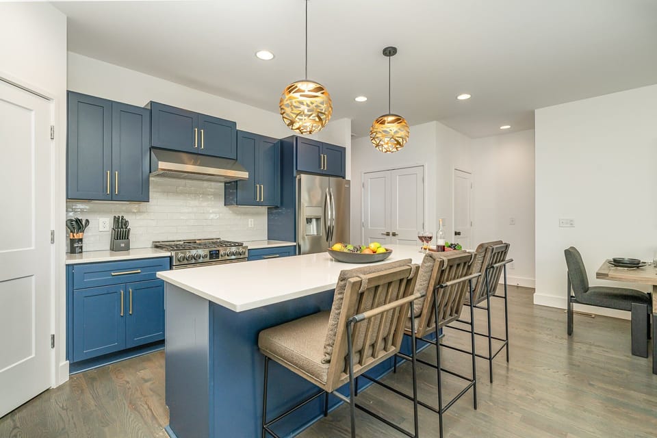 A bright, fully-equipped kitchen with modern appliances and plenty of counter space, ideal for preparing meals or enjoying casual snacks.
