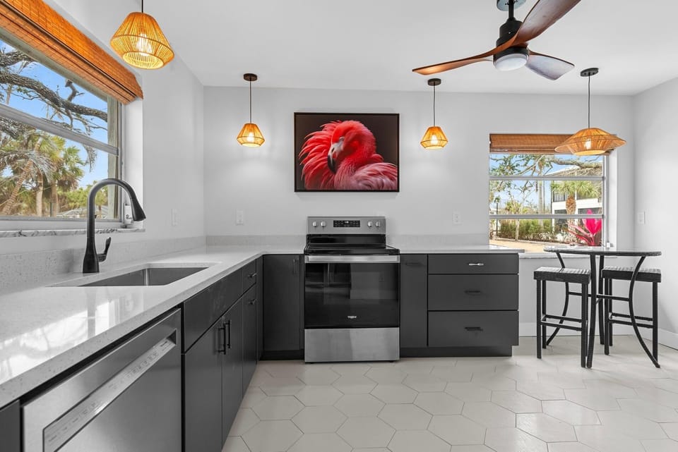 Enjoy the brand new kitchen!  Fully stocked and so pretty.  Plenty of countertop space and a pub table for "supervisors".