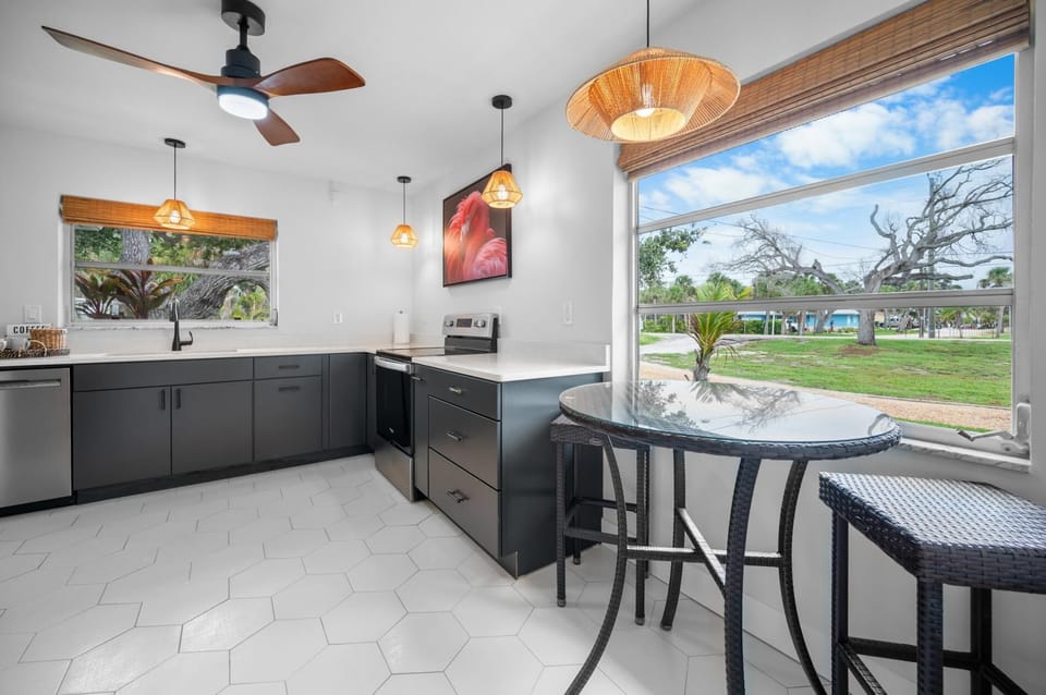 Enjoy the brand new kitchen!  Fully stocked and so pretty.  Plenty of countertop space and a pub table for "supervisors".
