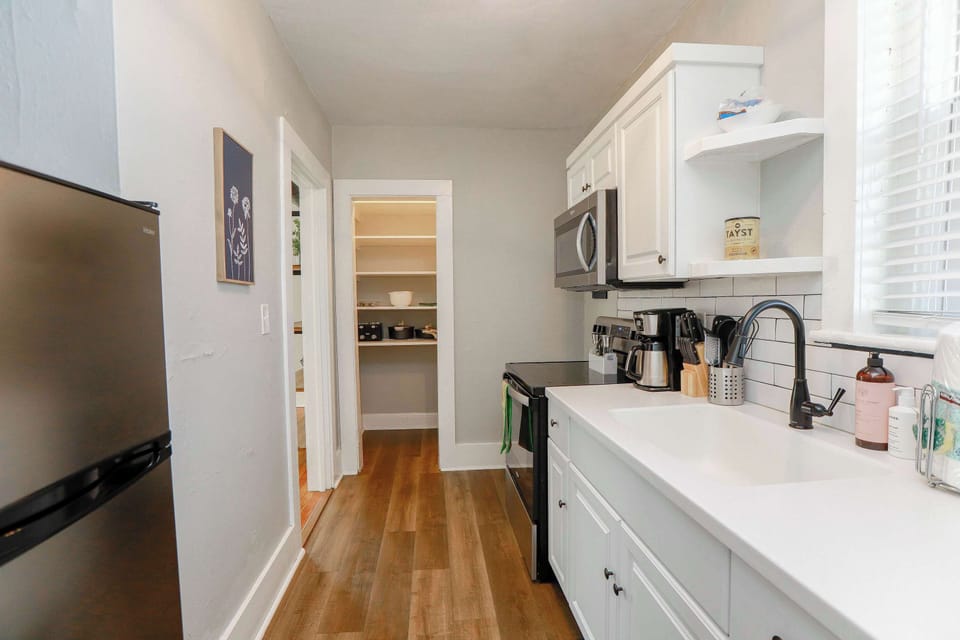 Kitchen with a view of the pantry space. 