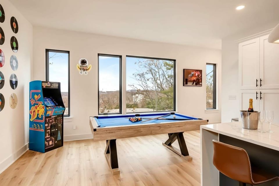 Pool table with a view and arcade rematches running late. This game room is the heartbeat of the house after dark