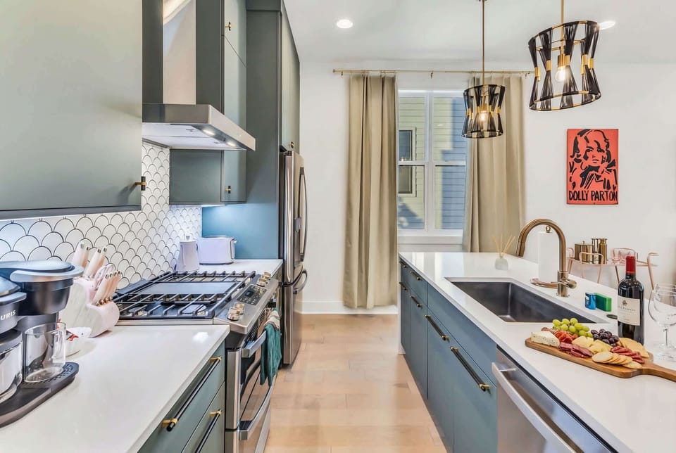 Natural light flows across the kitchen island, where your group will spend mornings and meal prep for gatherings, no one gets stuck cooking alone