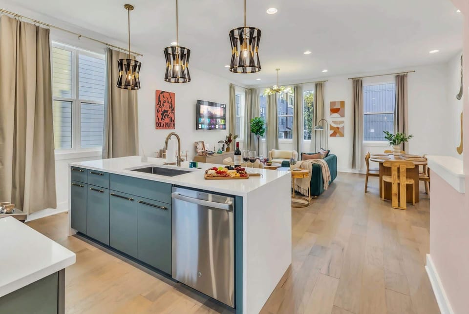 Cook together in this Nashville house's open kitchen, where the dark green island anchors a layout built for groups to prep, eat, and hang without splitting up