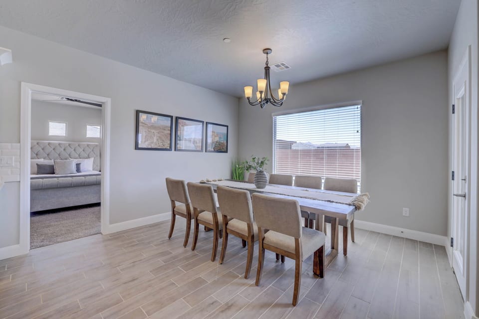 Bright dining space with large windows framing the pool and sunny ambiance