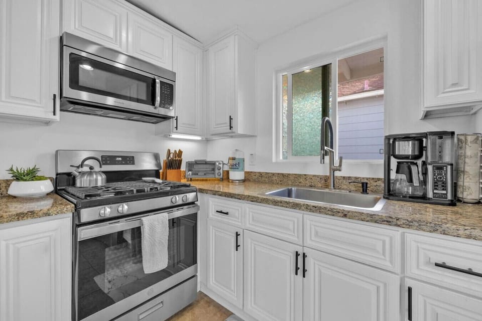 Fully stocked kitchen with blender, huge pots and coffee maker