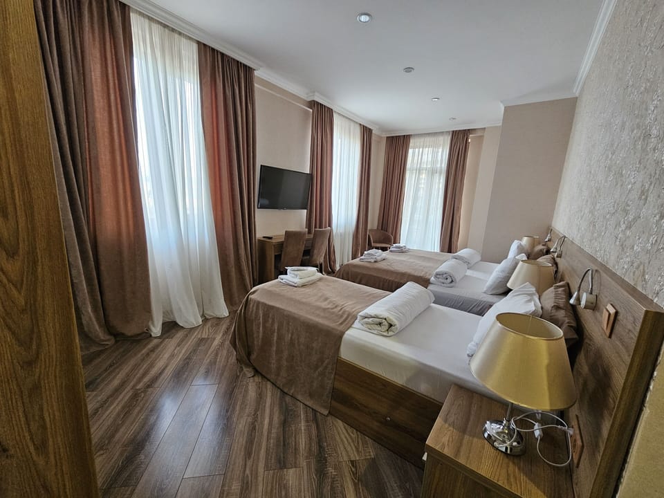 Deluxe Triple Room, City View | In-room safe, iron/ironing board, free WiFi