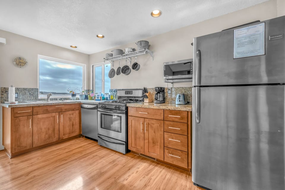 Cook meals with modern appliances while enjoying scenic views from your fully equipped kitchen.