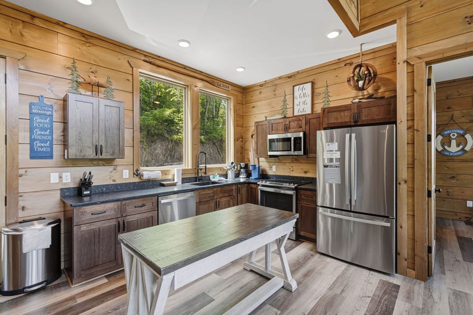 Cook memorable meals in your fully equipped rustic kitchen, featuring modern appliances and warm wood details for the perfect cabin experience.