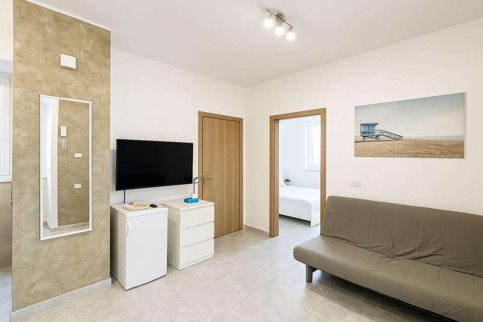 Comfort Apartment, Patio, Beach View | Living area | Flat-screen TV