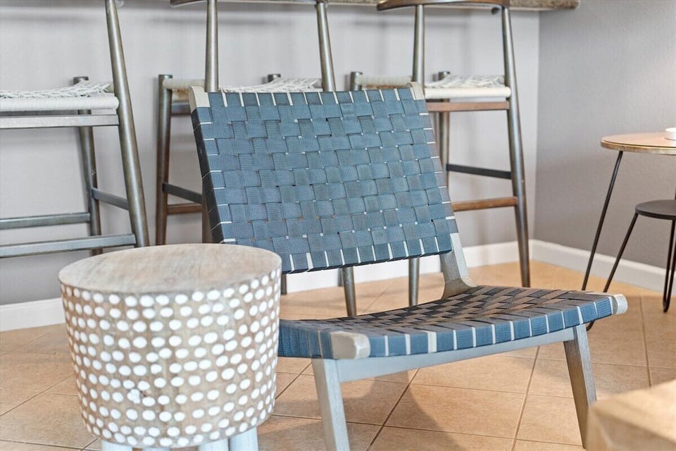 Stylish accent seating and coastal-inspired furnishings add comfort and charm to the living space.