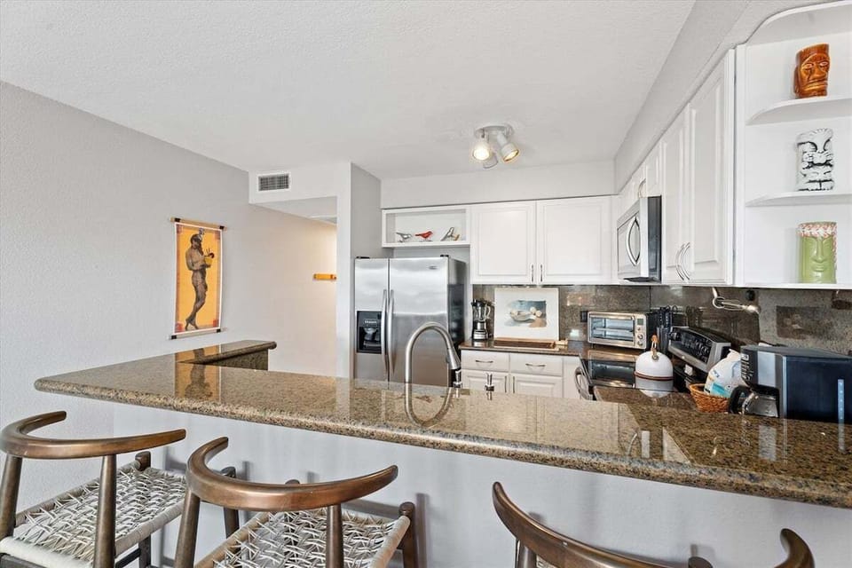 Bright kitchen and dining area featuring bar seating, ample counter space, and an open layout.