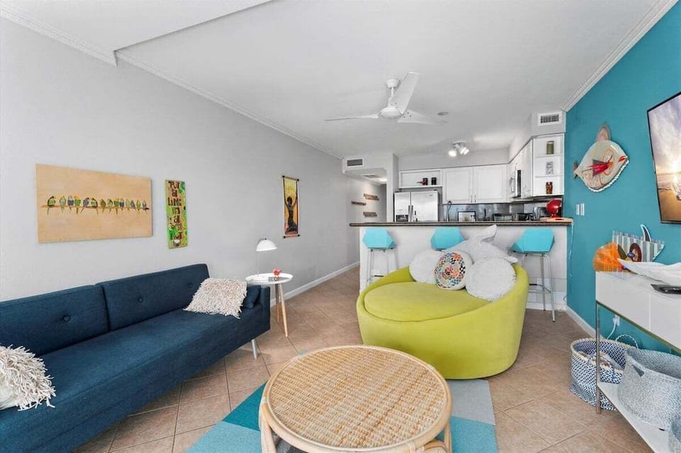 Stylish open living space featuring modern furnishings, comfortable lounge seating, and convenient access to the fully equipped kitchen.