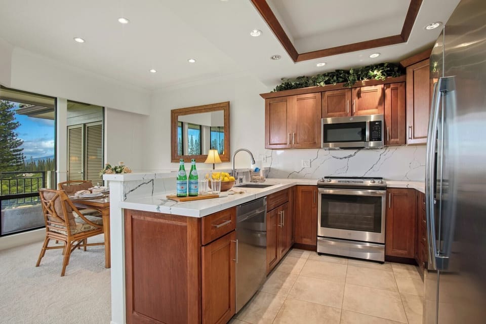 This kitchen pairs rich wood tones with crisp marble textures—perfect for morning brews and sunset sips alike   
