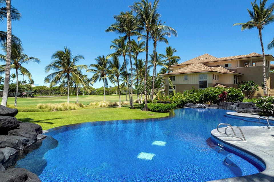 Outdoor pool with seating and tropical landscaping
