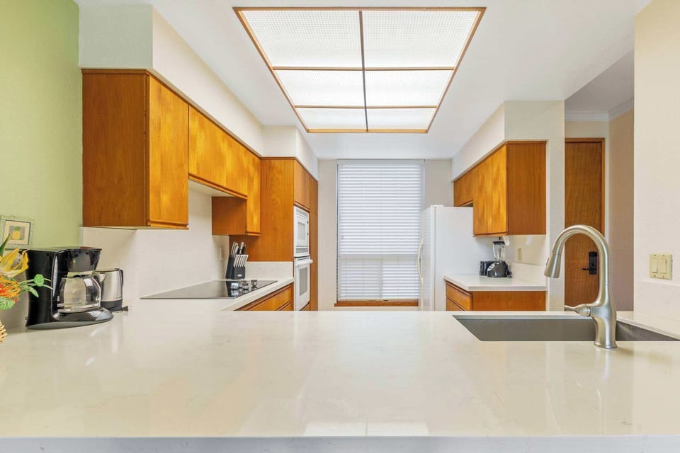 Kitchen with blender, drip coffee maker, kettle, toaster, and more