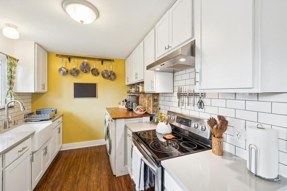 Galley kitchen with professional cookware and full-sized washer and dryer (detergent and softener sheets included).