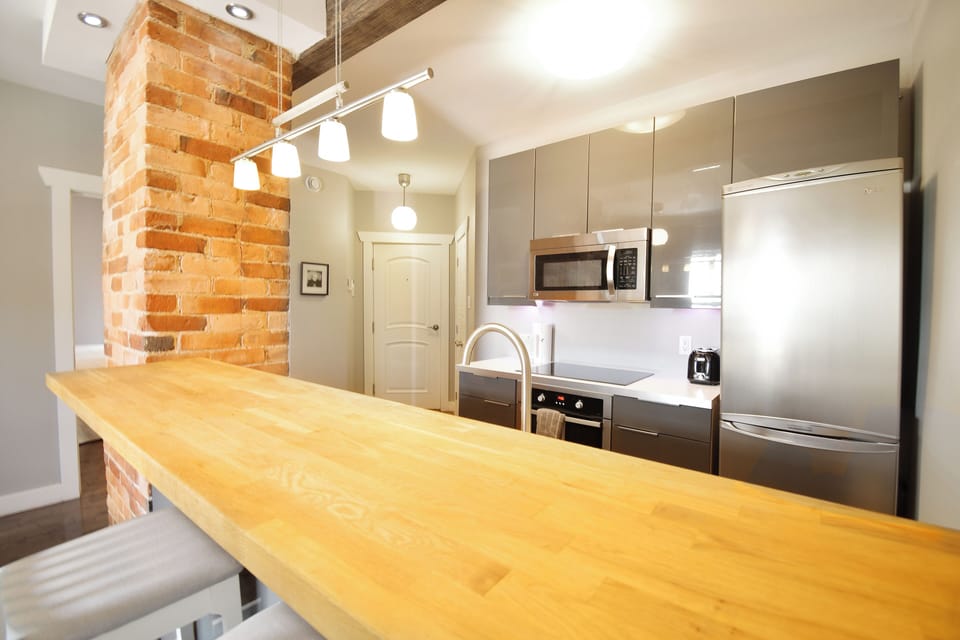 Signature Suite, 1 Queen Bed, Balcony | Private kitchen | Fridge, microwave, stovetop, coffee/tea maker