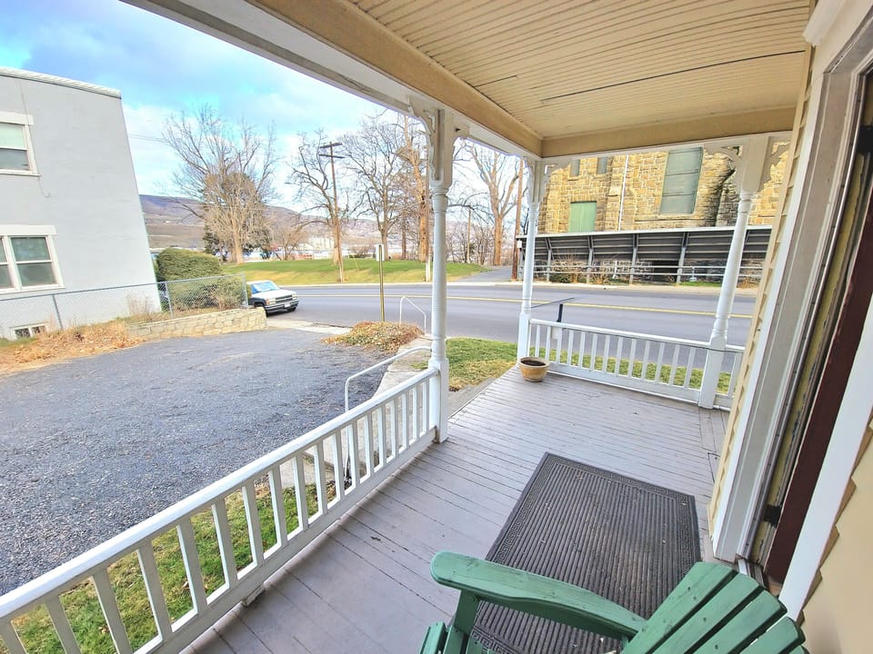 Back porch rear entry. Lighted gravel parking area.