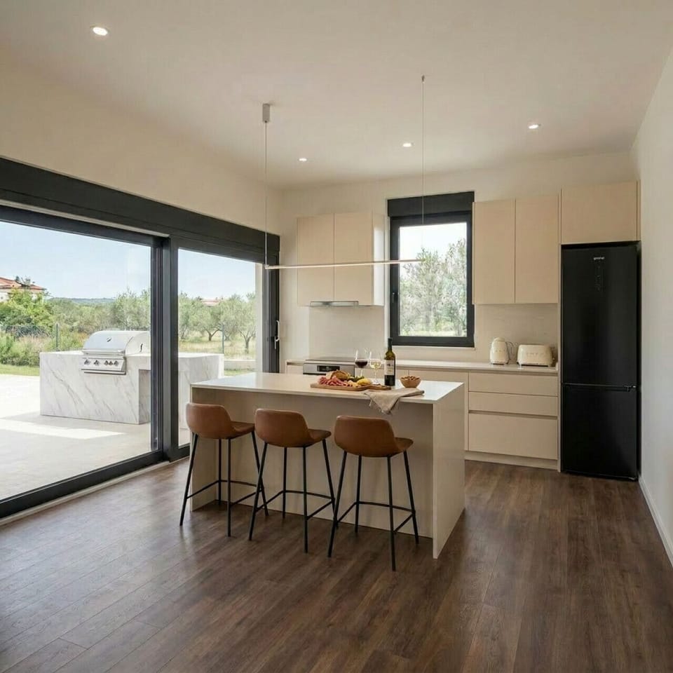 Fully equipped kitchen with breakfast bar — open the sliding doors and the outdoor grill is right there.