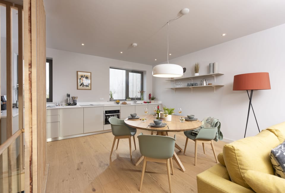 Lefransa, Carbis Bay. First floor: Head upstairs to find the gorgeous open-plan living space, complete with a contemporary kitchen, circular dining table and inviting sitting area
