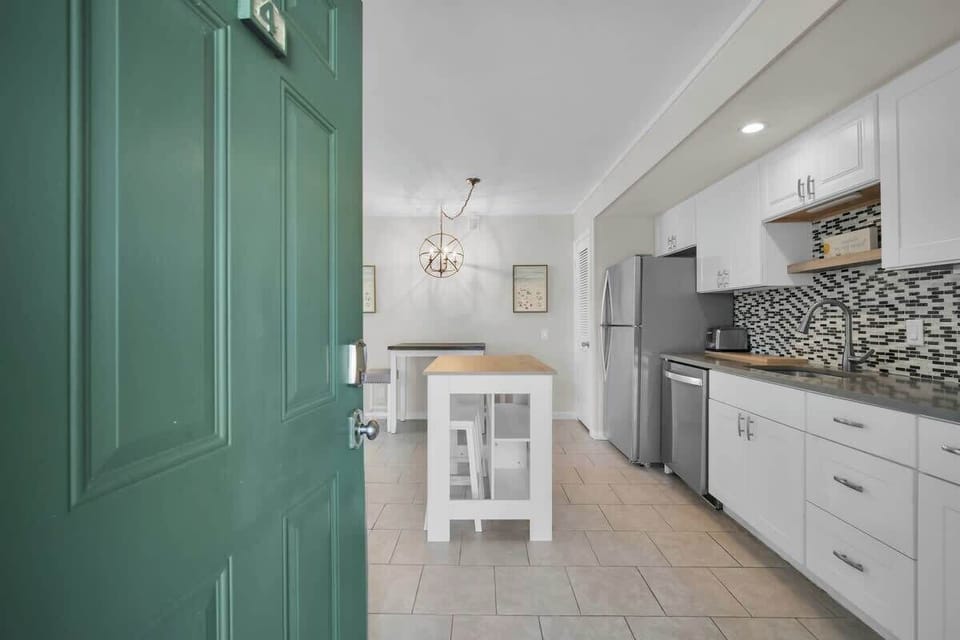 A functional kitchen island with a butcher block top provides extra prep space.

