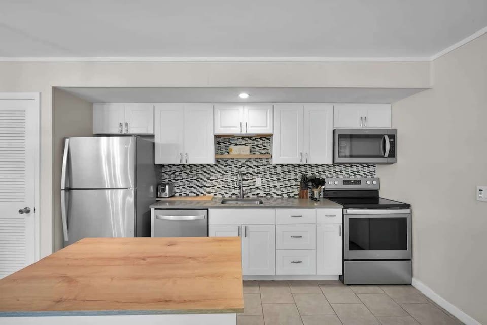 A fully equipped, modern kitchen with stainless steel appliances.