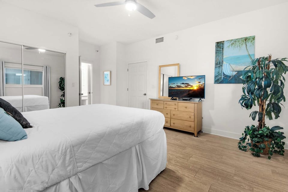 The guest bedroom has a flat-screen TV