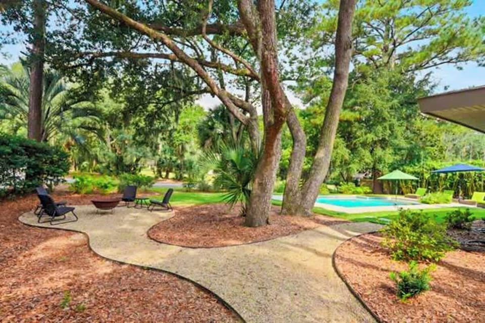 Backyard Pool and separate fire pit area, set beneath mature trees for shade and privacy