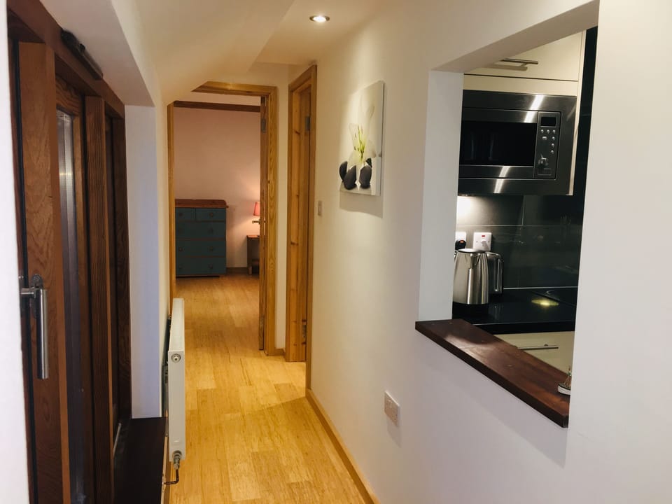 Hallway to bedroom and WC with kitchen on your right.