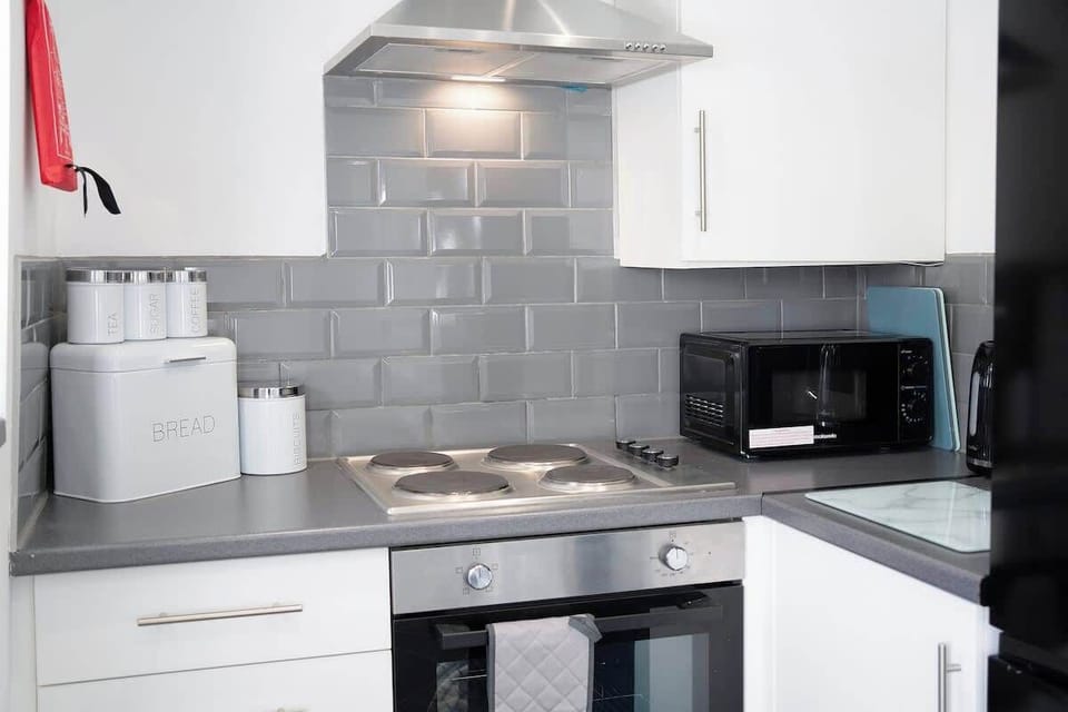 Kitchen equipped with all essentials, including a washer & dryer, oven, fridge and full cookware set.