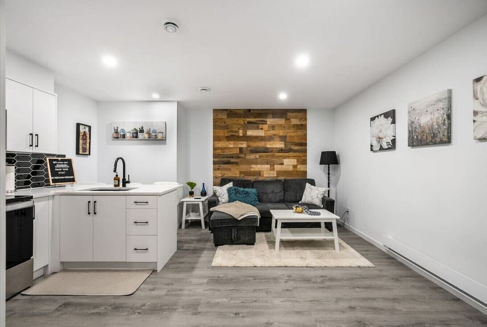 Living room with a 55` Smart/Roku TV and a pull-out sofa bed (bedding included.)