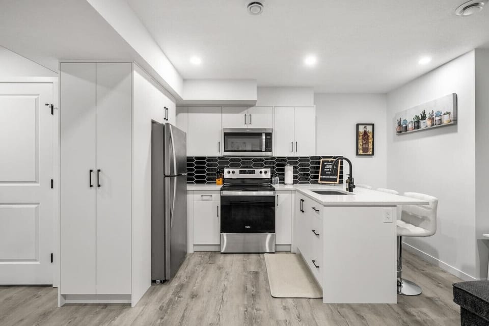 Full kitchen with drip & Keurig coffee makers, and island seating.
