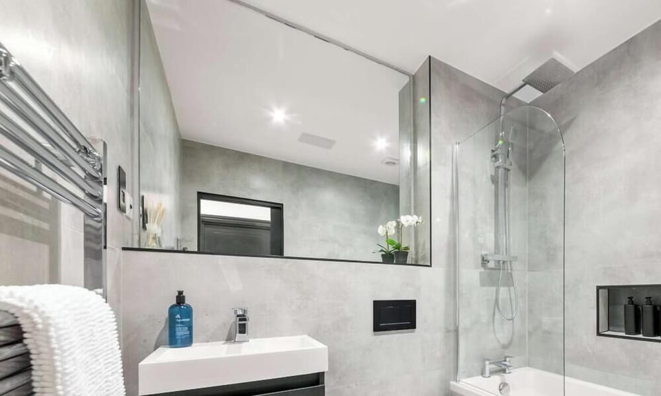 Featuring sleek finishes and a calming ambiance, this full bathroom offers a perfect space to unwind with a refreshing shower or a relaxing soak.