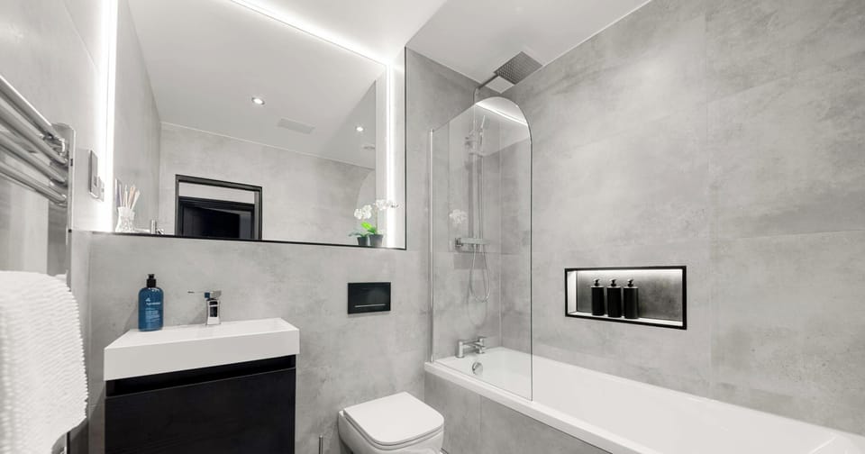 Featuring sleek finishes and a calming ambiance, this full bathroom offers a perfect space to unwind with a refreshing shower or a relaxing soak.
