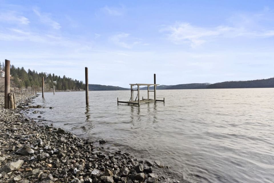Paddleboards, kayaks, and a canoe are ready for exploring the shoreline.