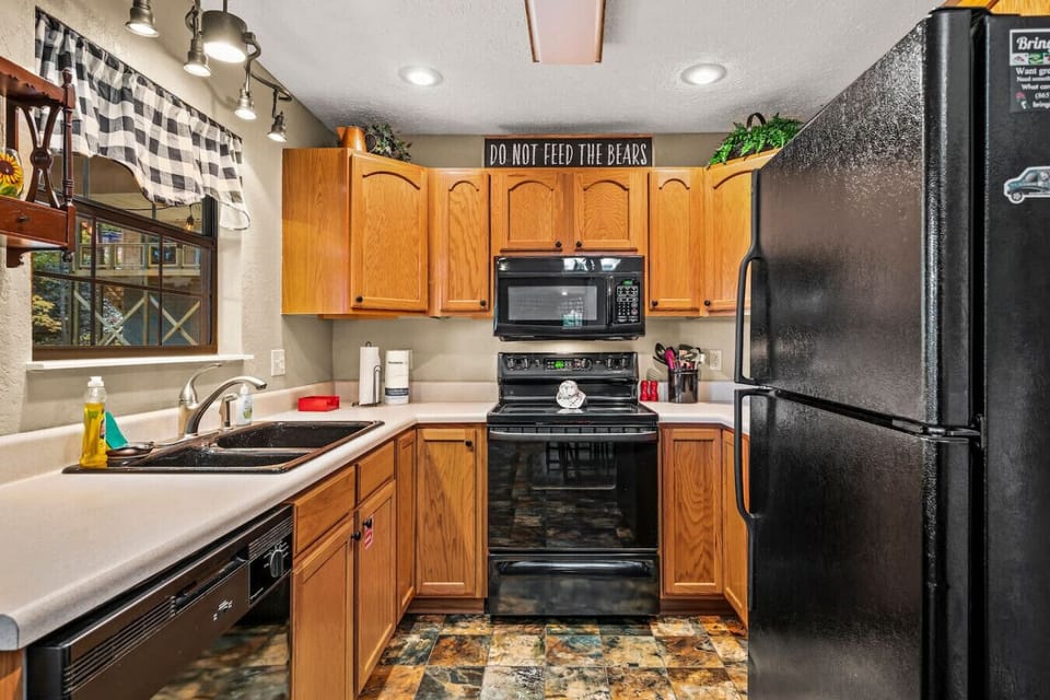 The fully equipped kitchen includes a stove, microwave, full-sized refrigerator, pots/pans, silverware, cookware and more.