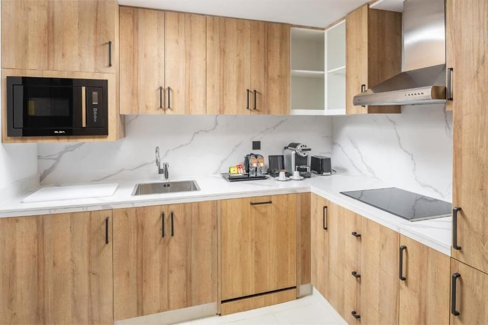 Full-size fridge, microwave, cookware/dishes/utensils, dining table